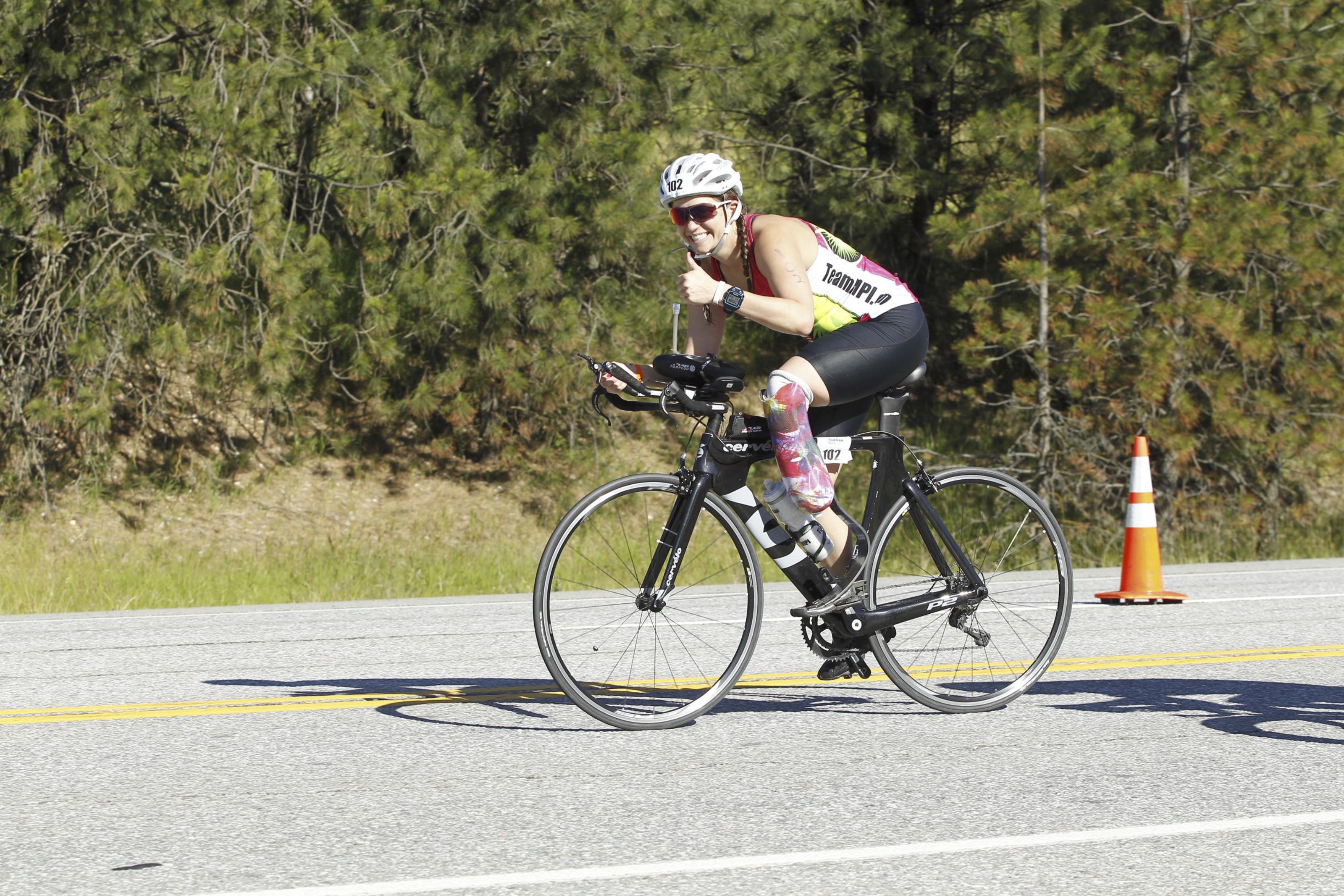 Emily on her bike giving a thumb's up to the camera during IM70.3 in Coeur d'Alene, June 2016