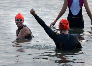 Becky and I in the water at the swim start - me smiling and Becky with her hand in the air cheering