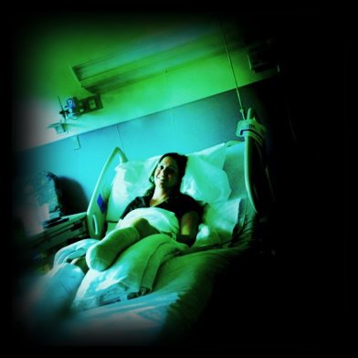 Emily in a hospital bed shortly after revision surgery in 2011
