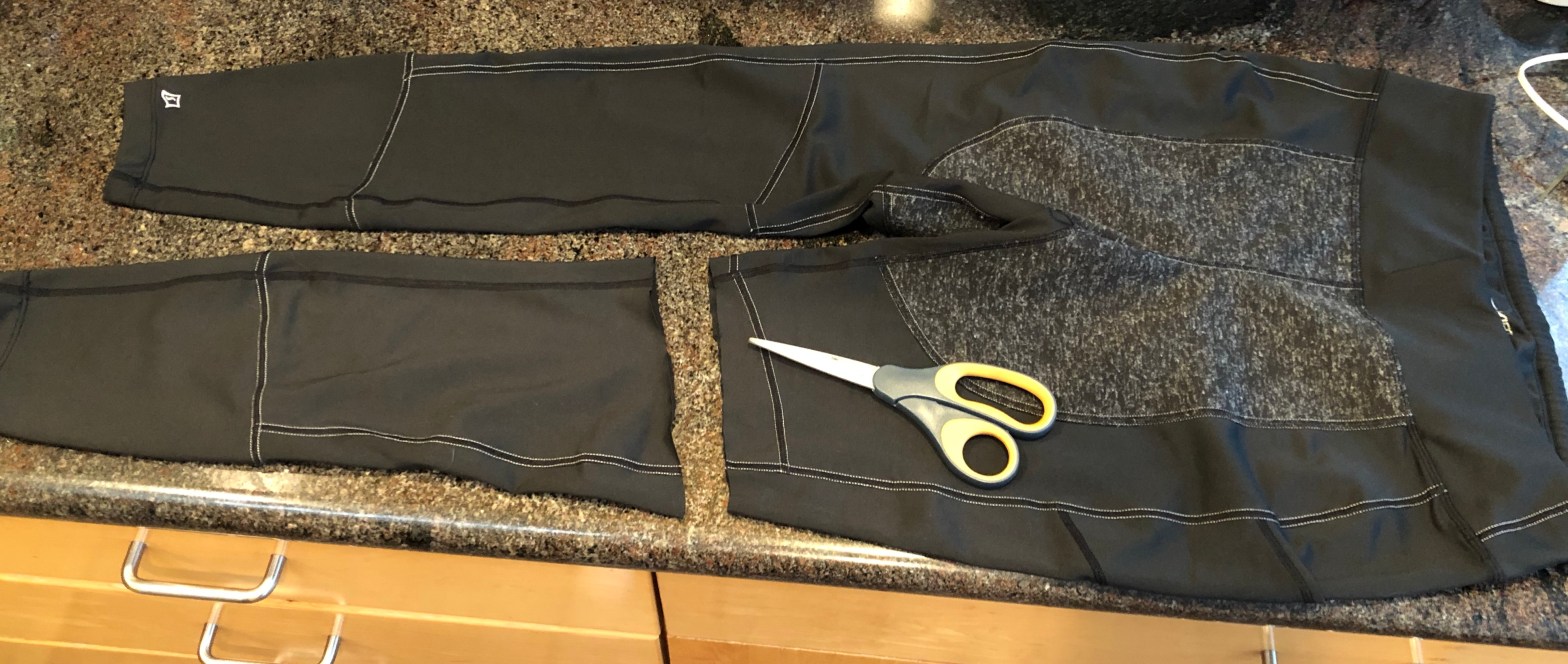same pair of running pants with scissors on them, but this time with the pant leg cut