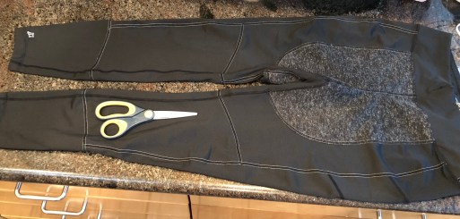 running tights with a pair of scissors lying on top of them