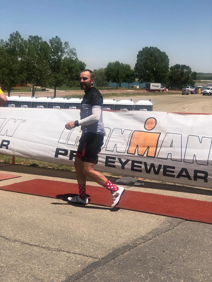Zach coming off the bike in his awesome outfit with lucky polka dot socks