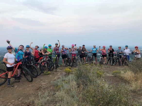 A group of women on top of South Table with their mountain bikes looking happy