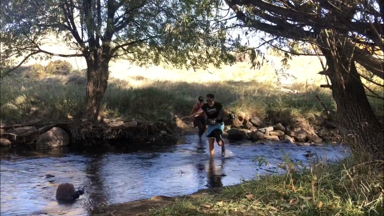 Me and Jessica crossing the creek at mile 8.5 of the race. Photo credit: Zach Harvey