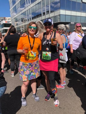 Jessica and me having a beer together after the Cherry Creek Sneak, both dressed in running skirts and bright colors